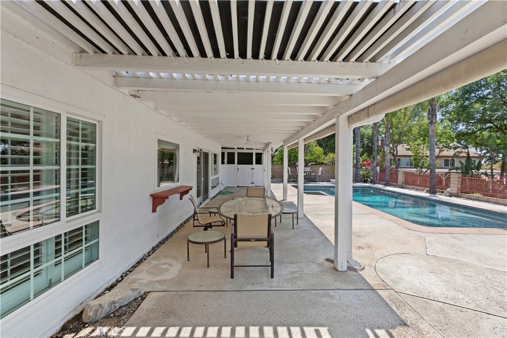 6225 Promontory Lane Riverside, CA 92506 - Photo 19 of 20 a view of a patio with a table chairs and wooden fence