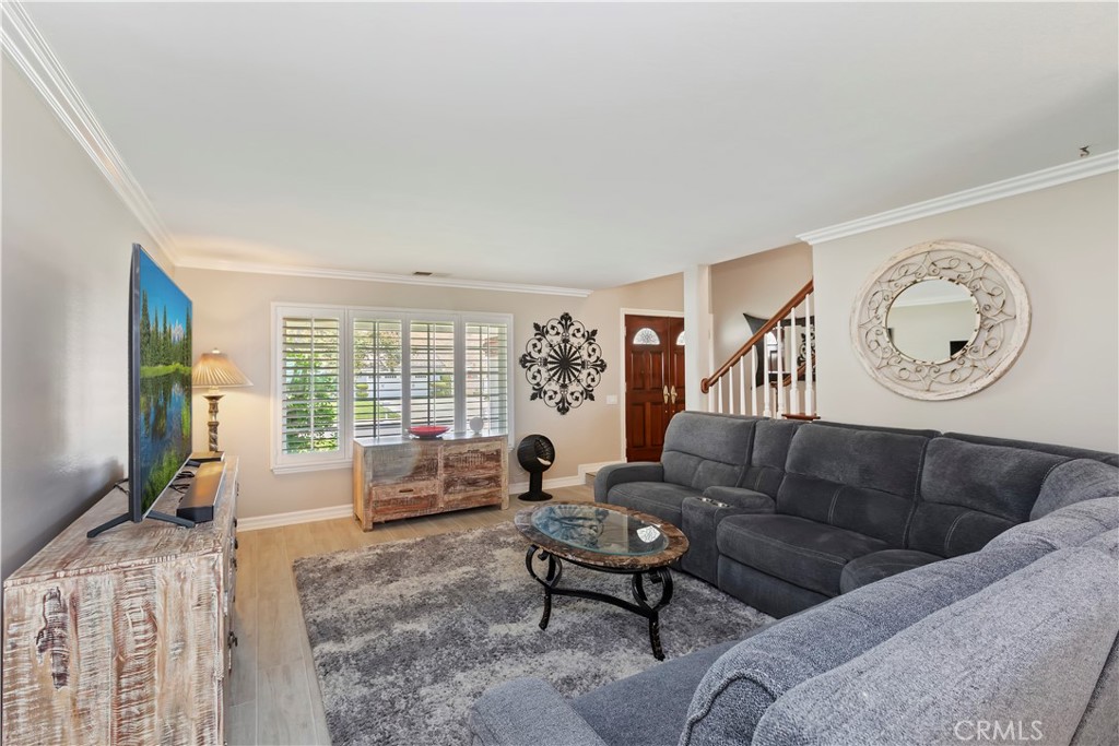 6225 Promontory Lane Riverside, CA 92506 - Photo 3 of 20 a living room with furniture a flat screen tv and a large window