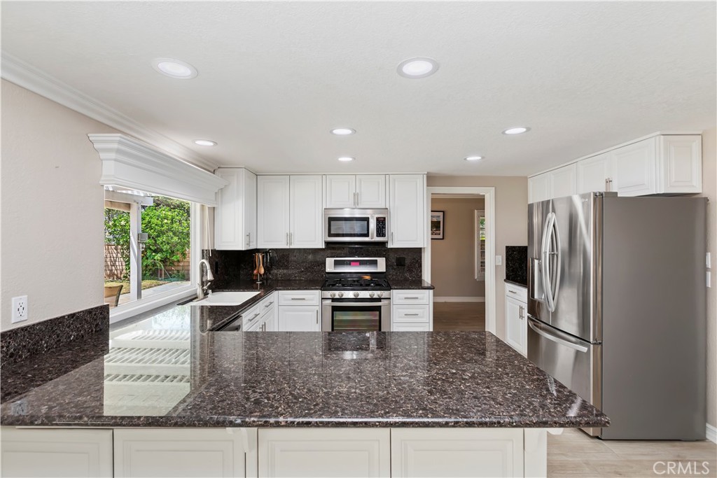 6225 Promontory Lane Riverside, CA 92506 - Photo 5 of 20 a kitchen with stainless steel appliances granite countertop a refrigerator sink and stove