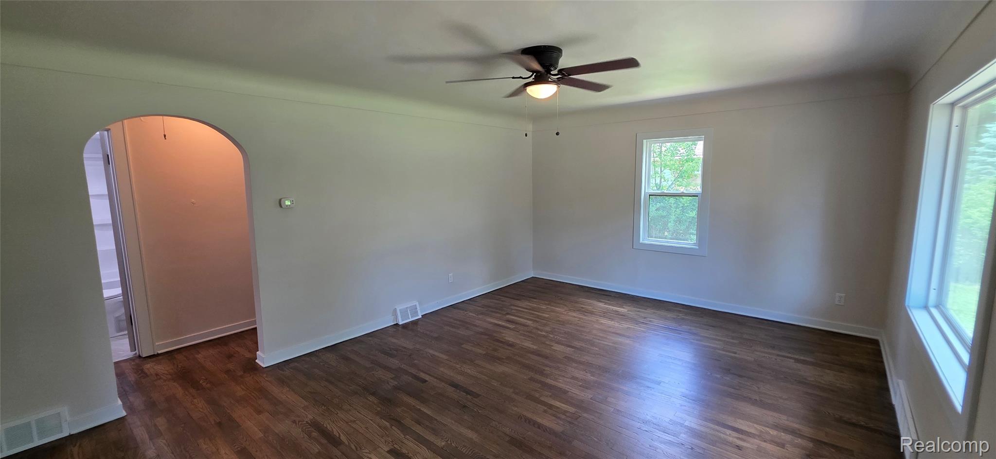 9205 Neff Road Clio, MI 48420 - Photo 6 of 35 Spacious interior room featuring wood-finish flooring, light neutral wall tones, and white trim