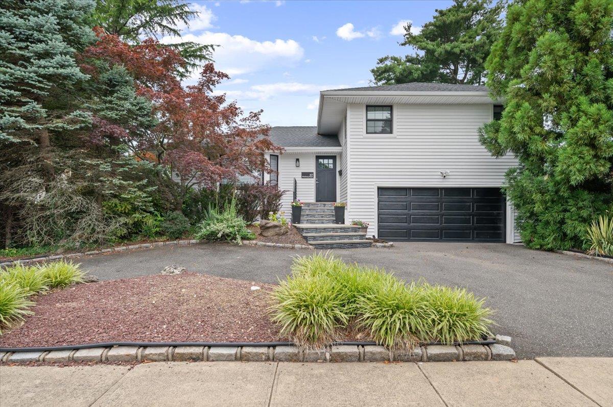 47 Winthrop Road Plainview, NY 11803 - Photo 1 of 1 a front view of a house with garden