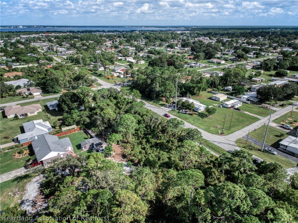 3308 Thunderbird Road Sebring, FL 33872 - Photo 4 of 6 an aerial view of a house and a yard and mountain