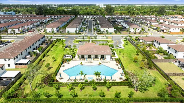 a view of a swimming pool with a yard