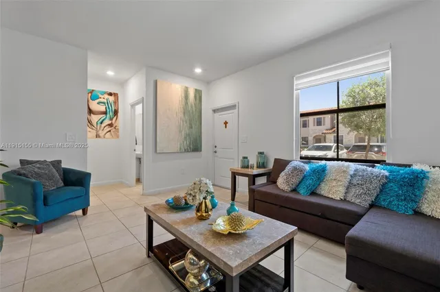 a living room with furniture and a large window