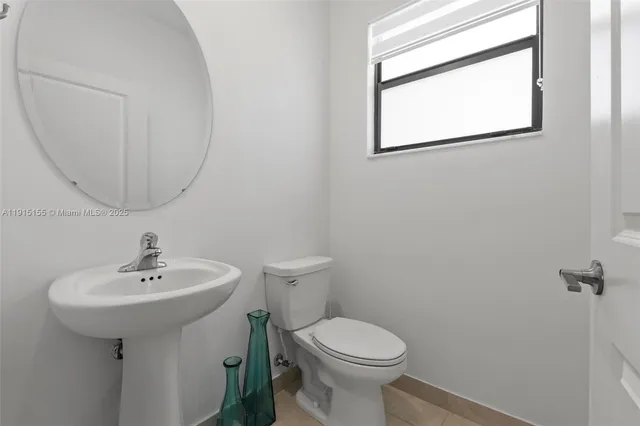 a bathroom with a sink a mirror and a toilet