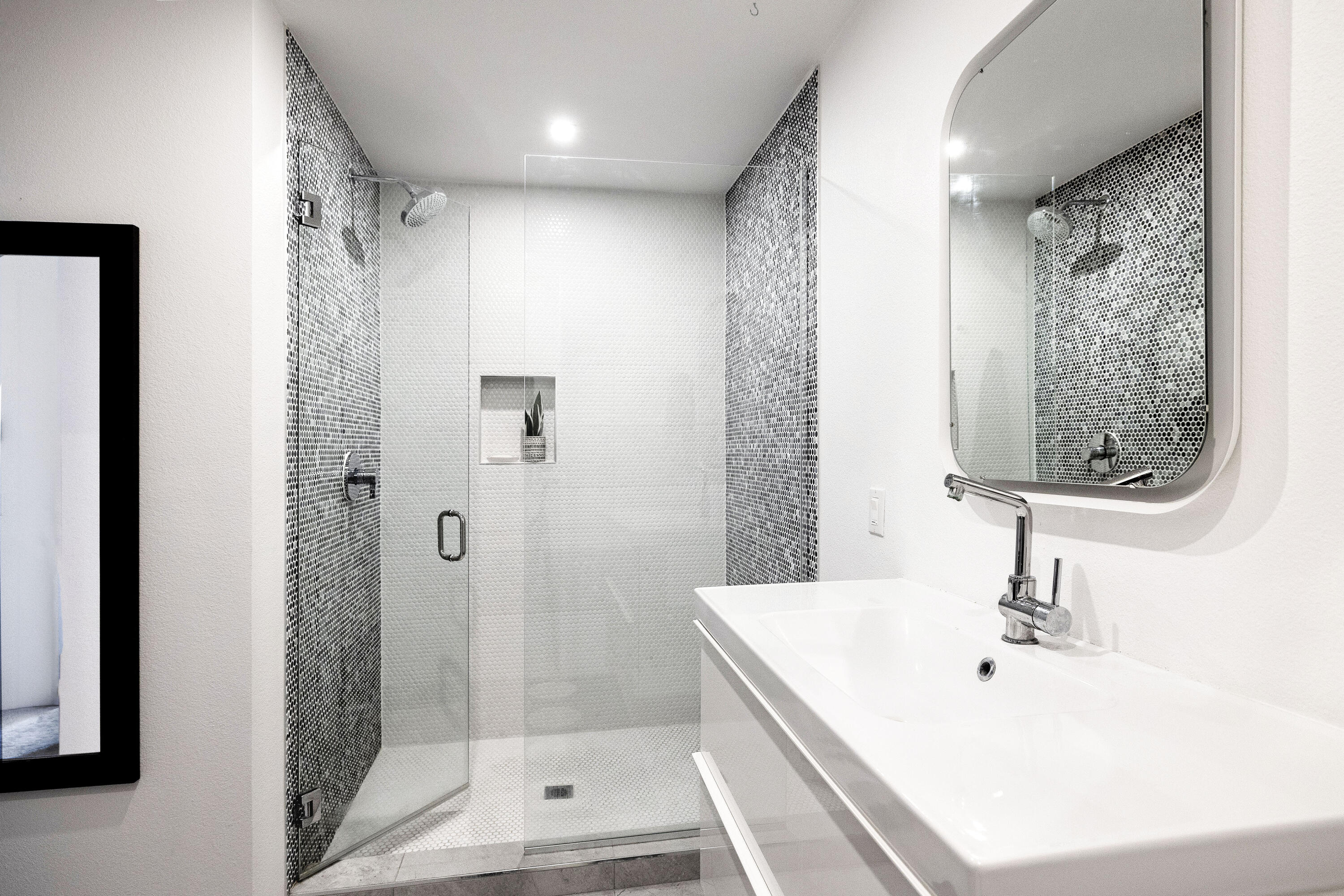 250 East Via Escuela, Unit G Palm Springs, CA 92262 - Photo 13 of 25 a bathroom with a sink a shower and a mirror