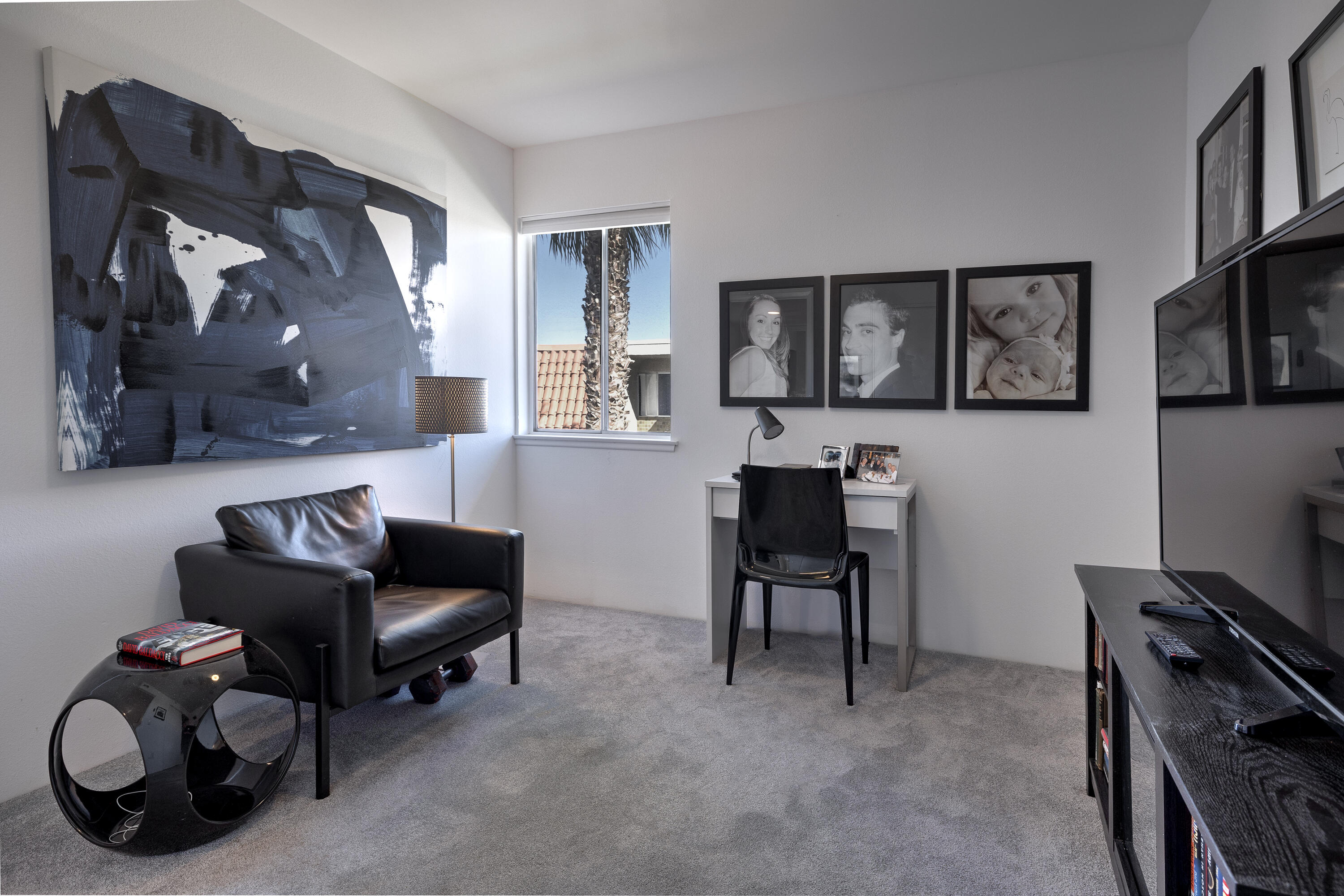 250 East Via Escuela, Unit G Palm Springs, CA 92262 - Photo 17 of 25 a livingroom with workspace and a couch