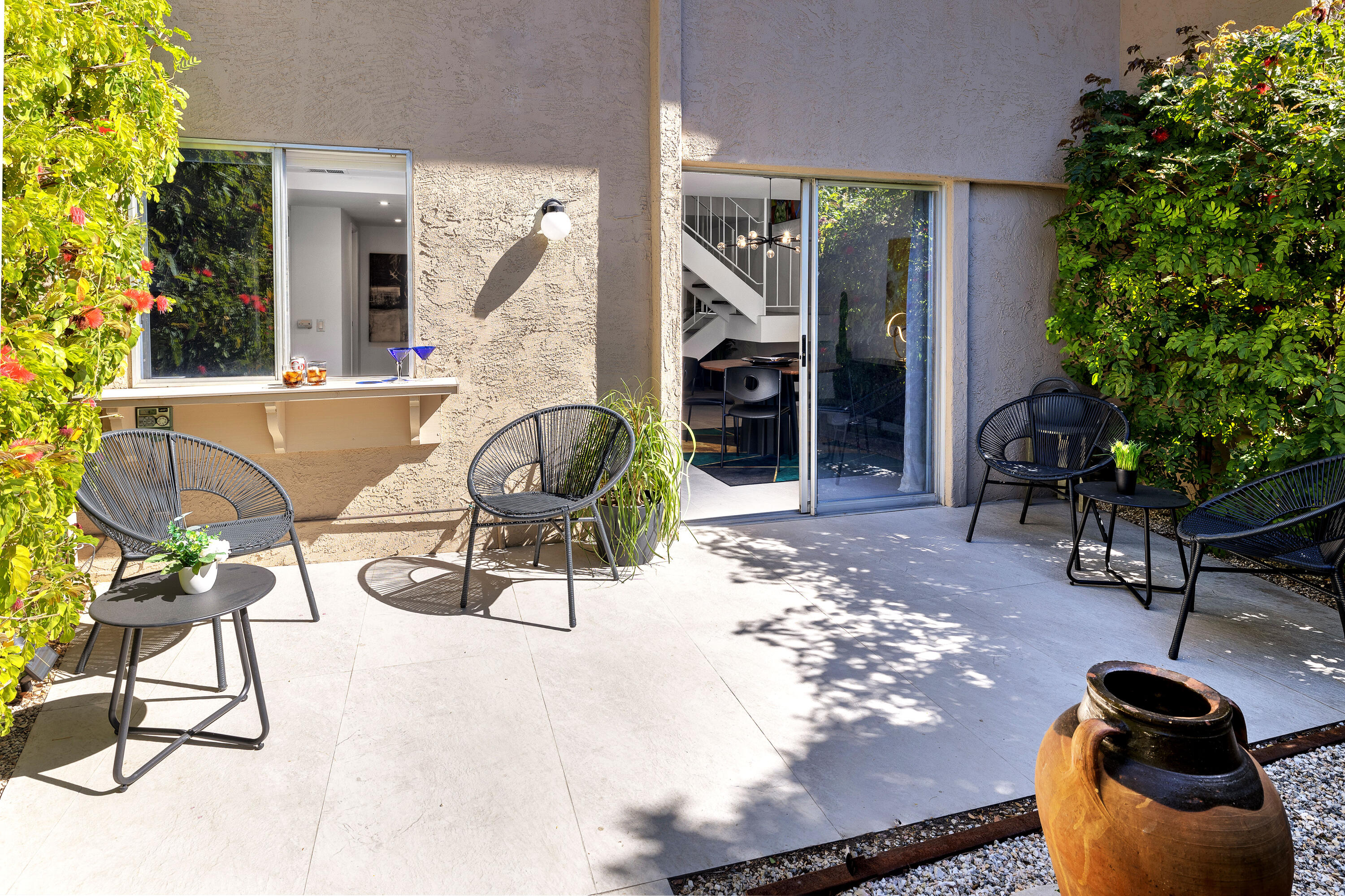 250 East Via Escuela, Unit G Palm Springs, CA 92262 - Photo 19 of 25 a view of a chairs and tables in patio