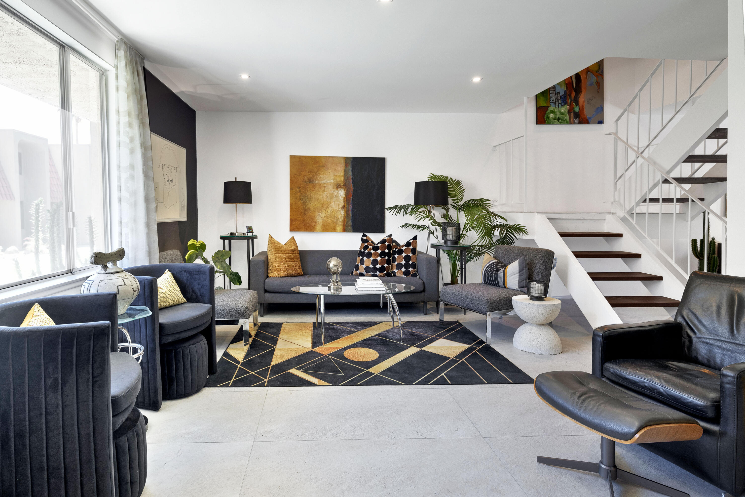 250 East Via Escuela, Unit G Palm Springs, CA 92262 - Photo 2 of 25 a living room with furniture and a flat screen tv