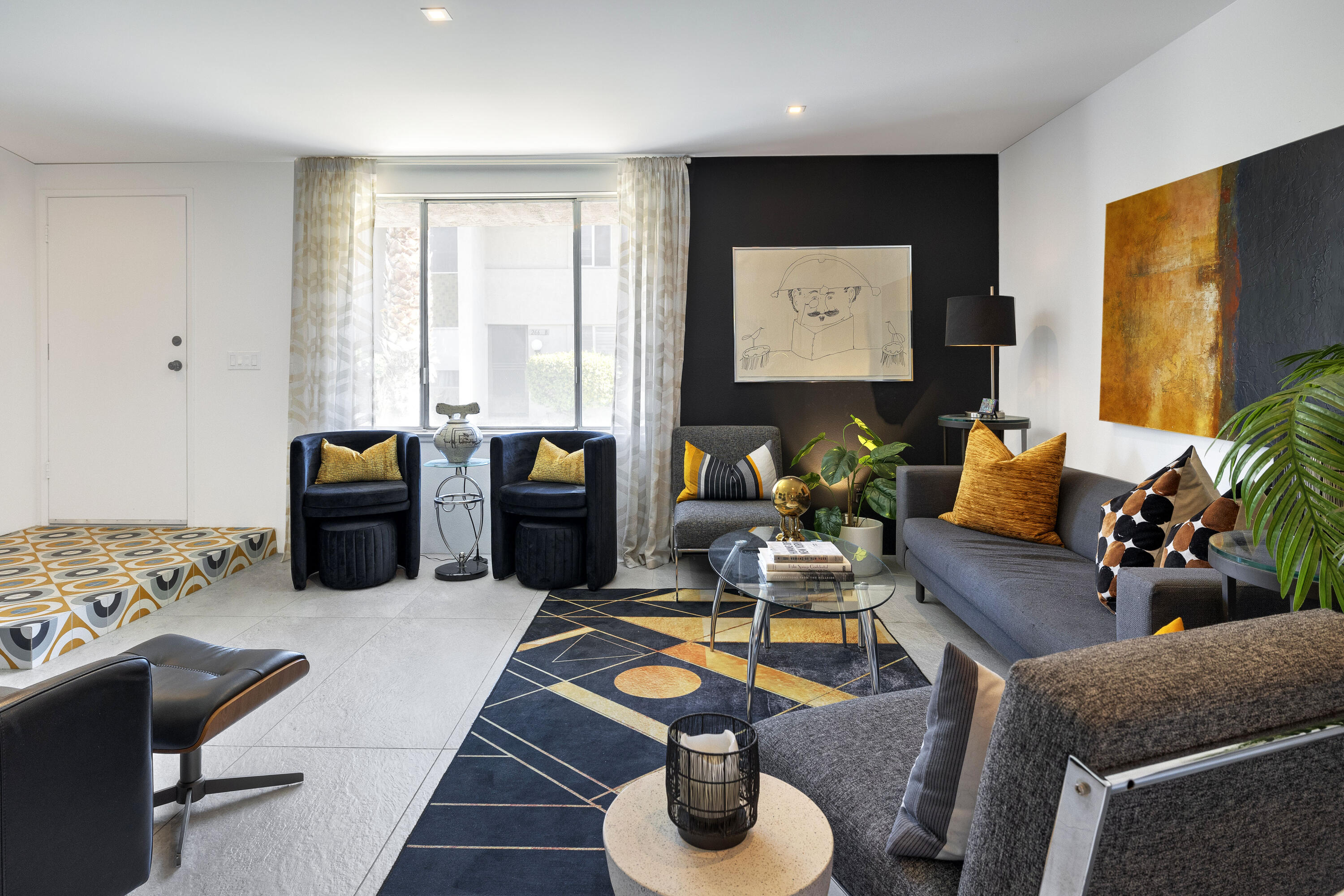 250 East Via Escuela, Unit G Palm Springs, CA 92262 - Photo 4 of 25 a living room with furniture and painting on the wall