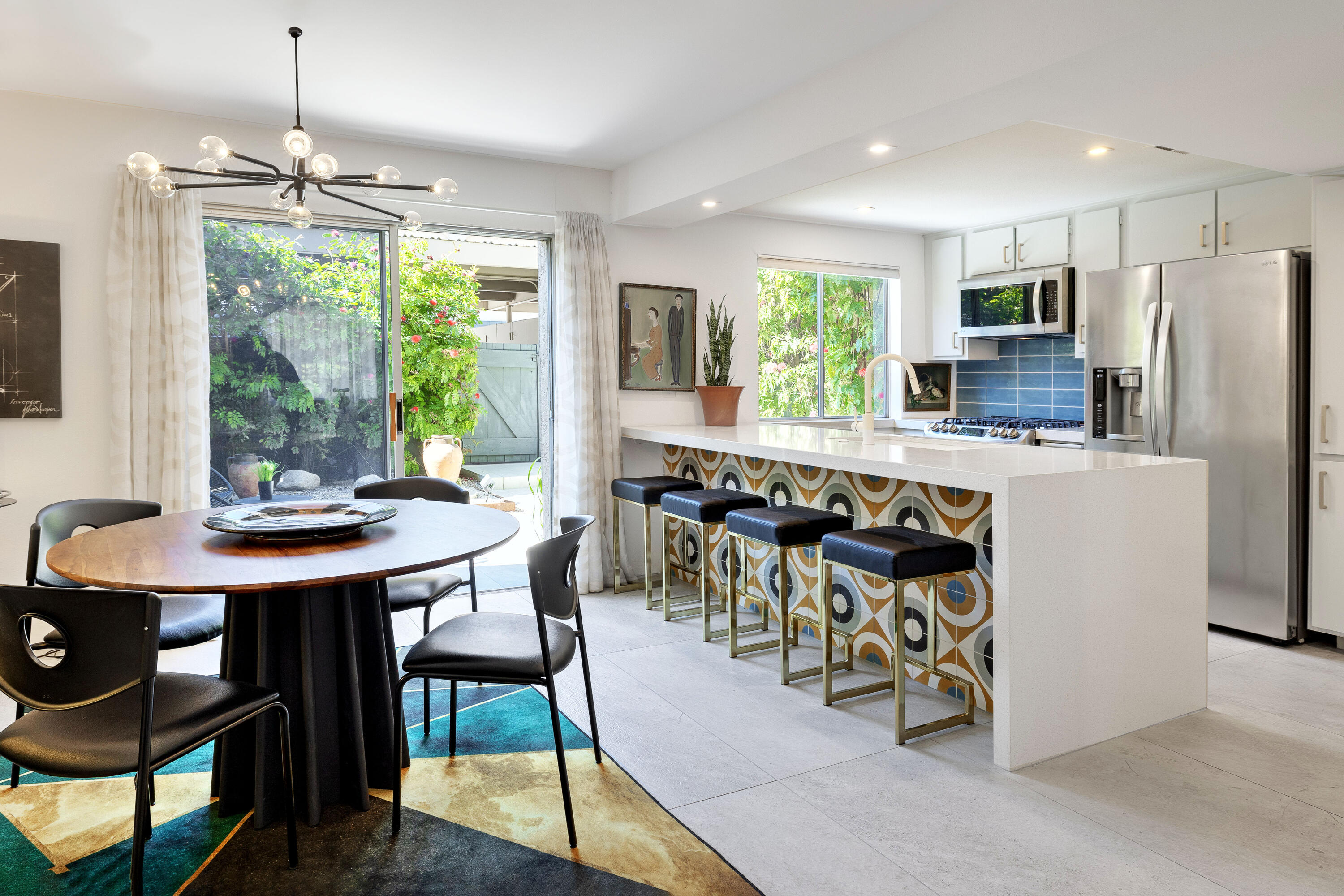 250 East Via Escuela, Unit G Palm Springs, CA 92262 - Photo 6 of 25 a view of a dining room with furniture window and outside view