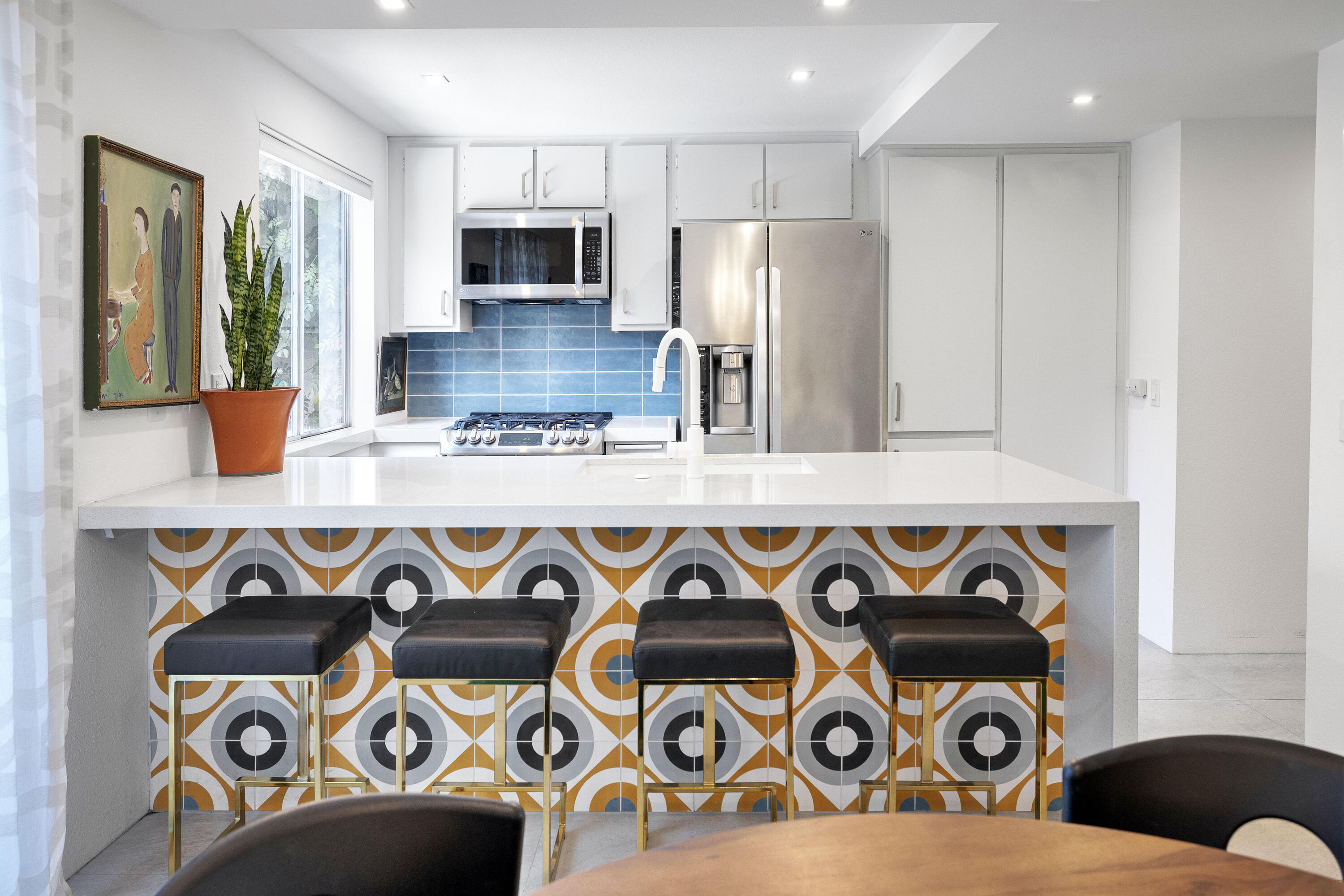 250 East Via Escuela, Unit G Palm Springs, CA 92262 - Photo 7 of 25 a kitchen with stainless steel appliances granite countertop a stove and a sink