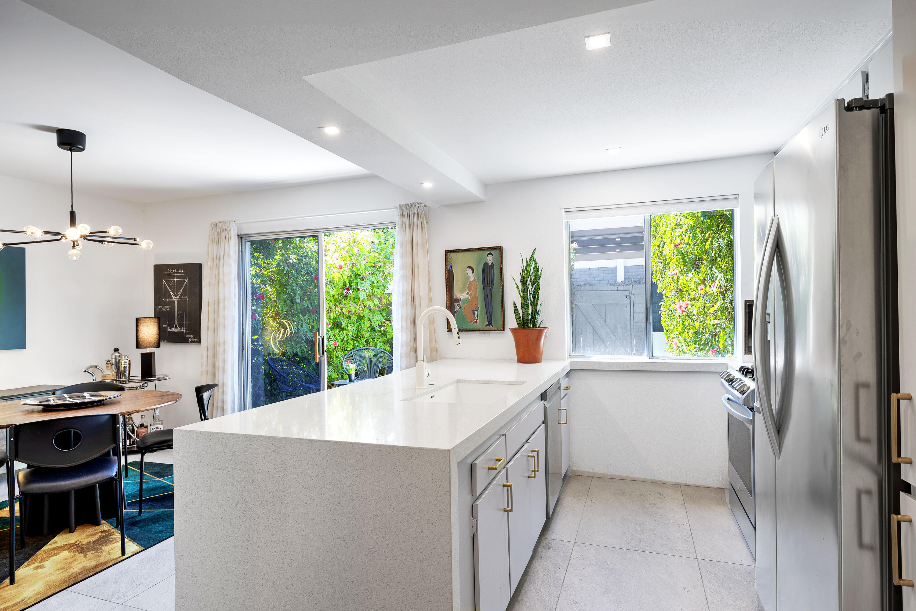 250 East Via Escuela, Unit G Palm Springs, CA 92262 - Photo 8 of 25 a large white kitchen with a large window