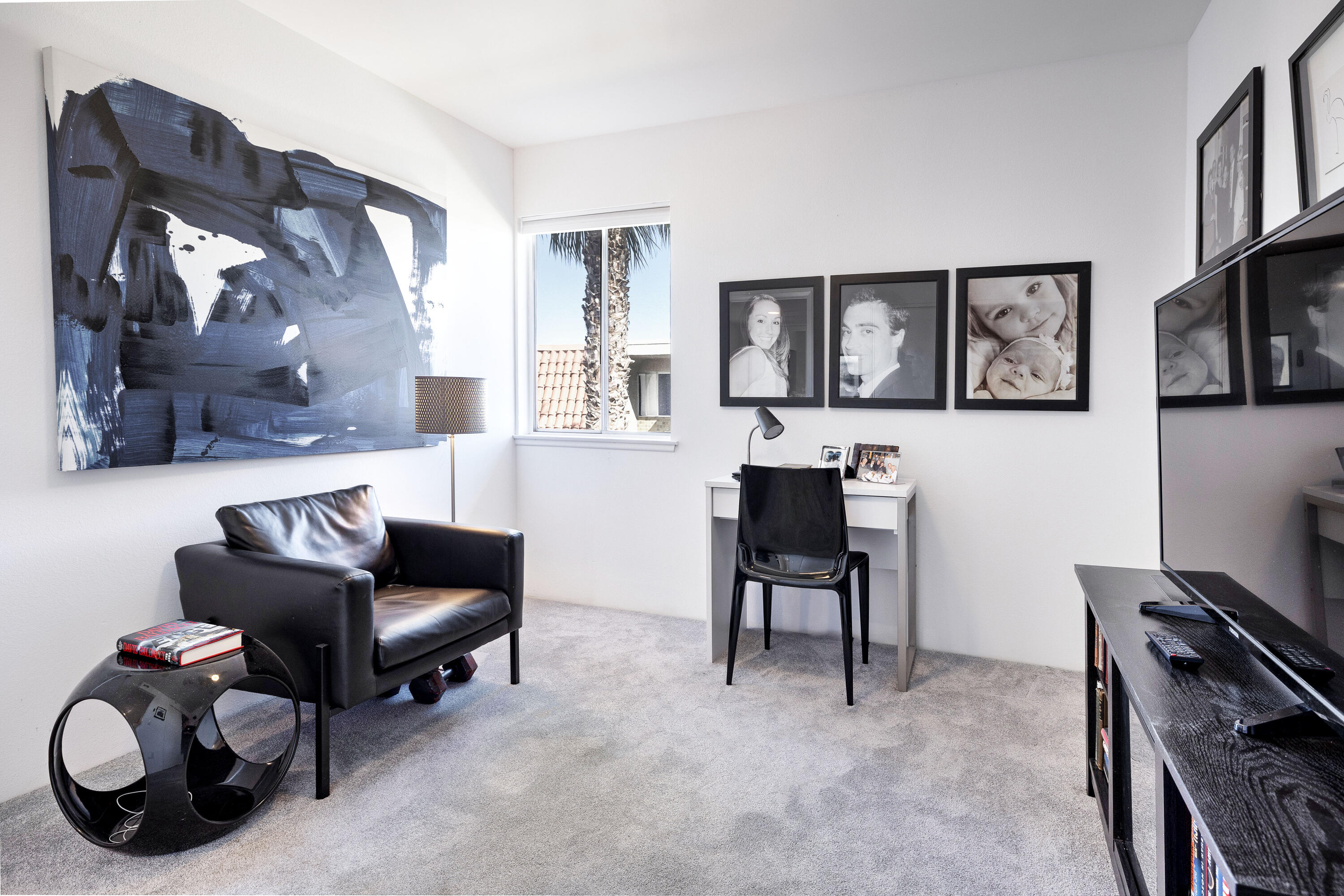 250 East Via Escuela, Unit G Palm Springs, CA 92262 - Photo 9 of 25 a livingroom with workspace and a couch