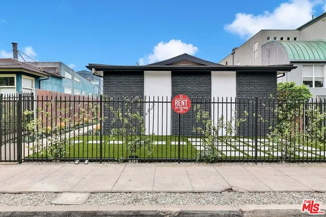 a view of a house with a small yard and plants