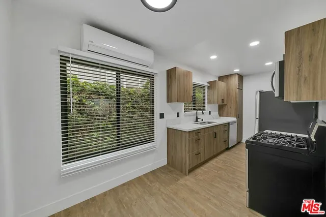 a kitchen with a sink and a stove top oven