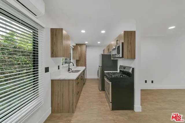 a kitchen with a sink appliances and cabinets