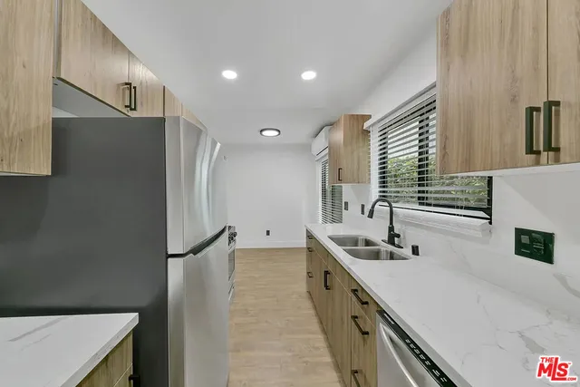 a kitchen with a sink a refrigerator and a stove