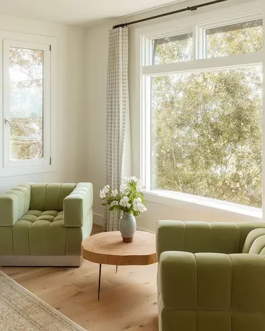 a living room with furniture and potted plant