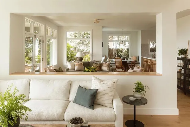 a view of a living room and a livingroom with furniture wooden floor a chandelier
