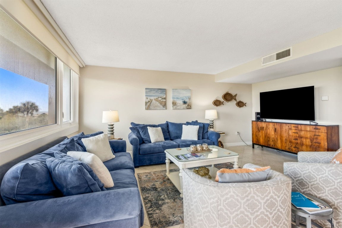 1107 Beach Walker Road, Unit 1107 Fernandina Beach, FL 32034 - Photo 10 of 63 a living room with furniture and a flat screen tv