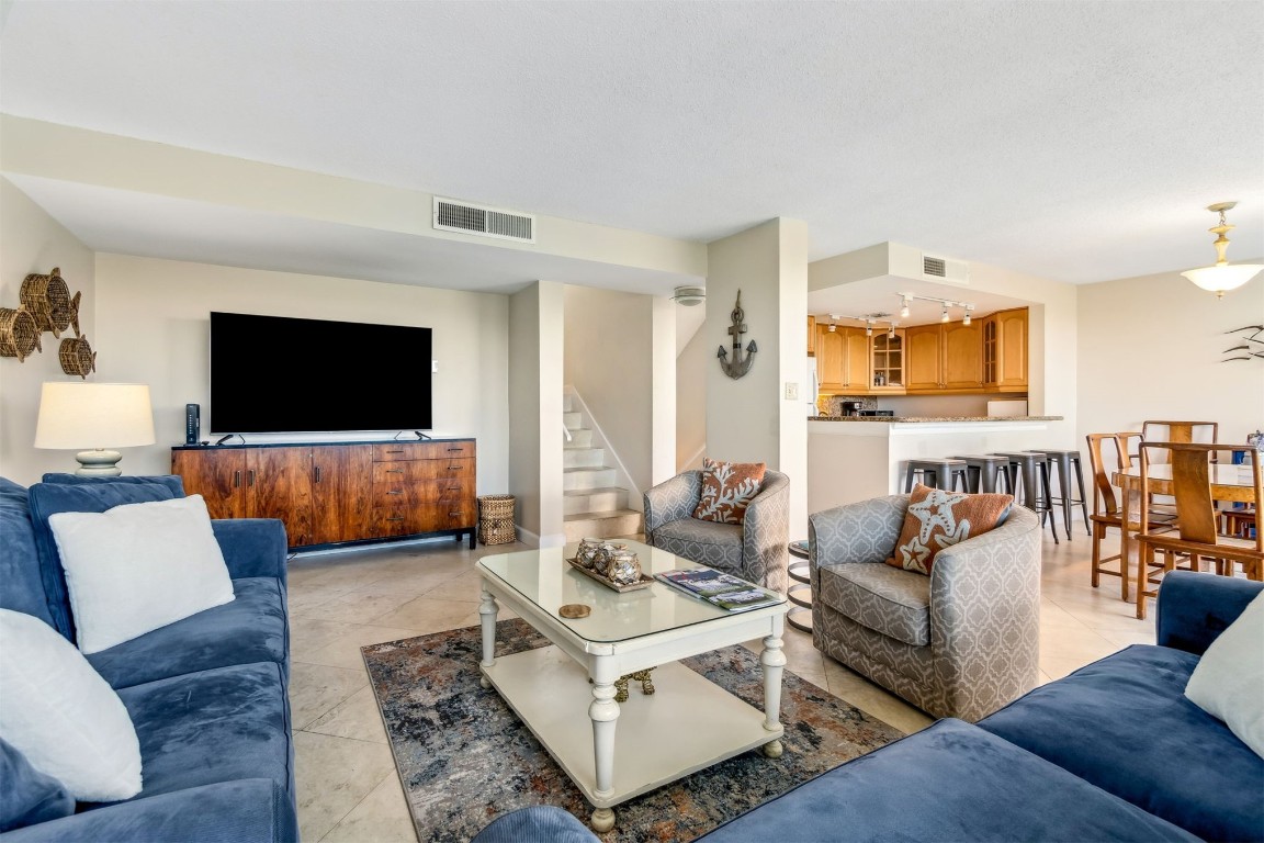 1107 Beach Walker Road, Unit 1107 Fernandina Beach, FL 32034 - Photo 11 of 63 a living room with furniture and a flat screen tv