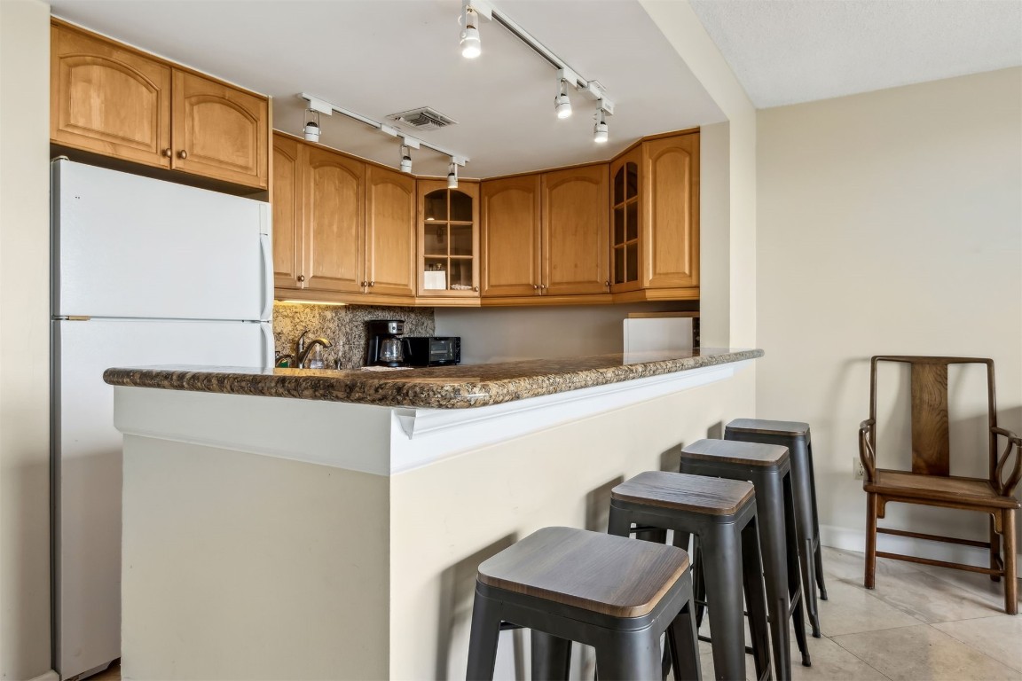 1107 Beach Walker Road, Unit 1107 Fernandina Beach, FL 32034 - Photo 14 of 63 a kitchen with stainless steel appliances granite countertop a sink and a refrigerator