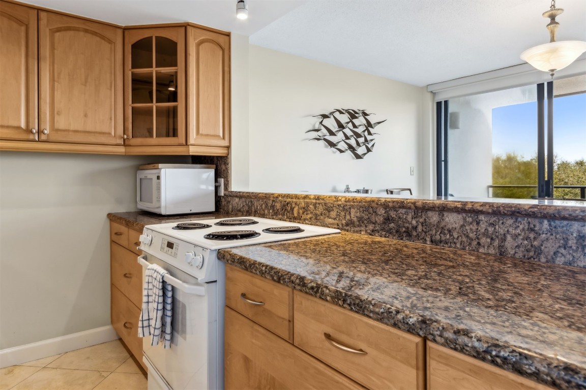 1107 Beach Walker Road, Unit 1107 Fernandina Beach, FL 32034 - Photo 16 of 63 a kitchen with a stove and a sink