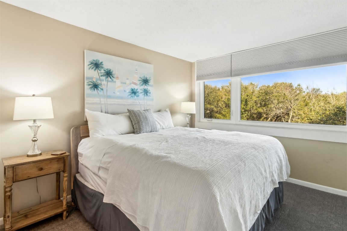 1107 Beach Walker Road, Unit 1107 Fernandina Beach, FL 32034 - Photo 18 of 63 a bedroom with a bed and a painting on the wall