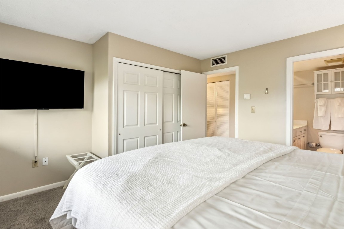 1107 Beach Walker Road, Unit 1107 Fernandina Beach, FL 32034 - Photo 19 of 63 a bedroom with a bed and a flat screen tv