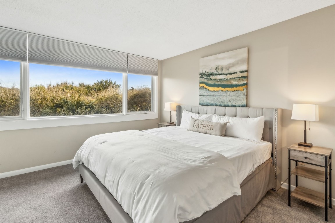 1107 Beach Walker Road, Unit 1107 Fernandina Beach, FL 32034 - Photo 22 of 63 a bedroom with a bed and a large window