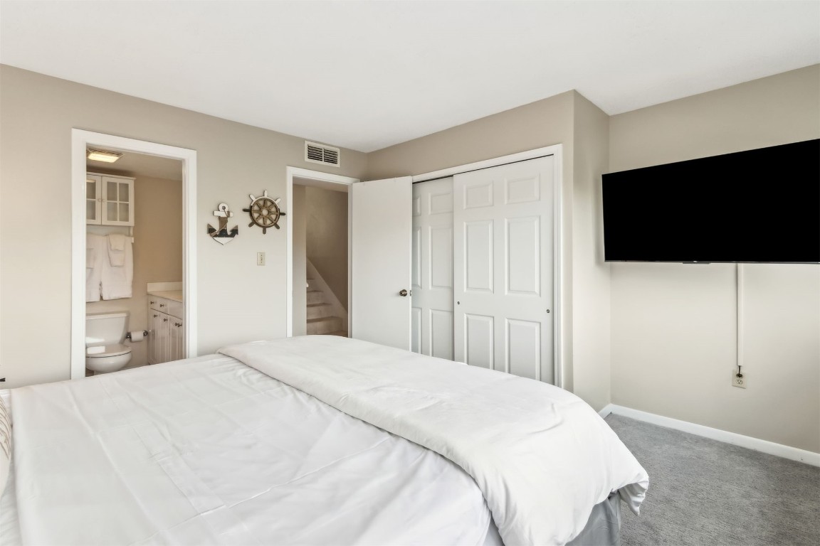 1107 Beach Walker Road, Unit 1107 Fernandina Beach, FL 32034 - Photo 23 of 63 a bedroom with a bed and a flat screen tv
