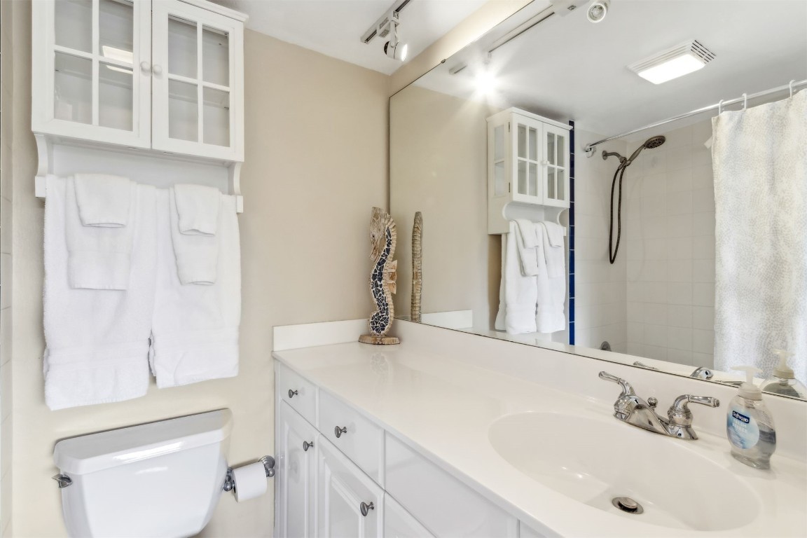 1107 Beach Walker Road, Unit 1107 Fernandina Beach, FL 32034 - Photo 24 of 63 a bathroom with a granite countertop sink a toilet and shower