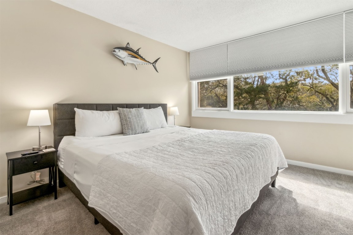 1107 Beach Walker Road, Unit 1107 Fernandina Beach, FL 32034 - Photo 25 of 63 a bedroom with a bed and a night stand