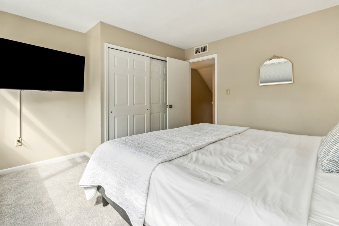 1107 Beach Walker Road, Unit 1107 Fernandina Beach, FL 32034 - Photo 26 of 63 a bedroom with a bed and a flat screen tv