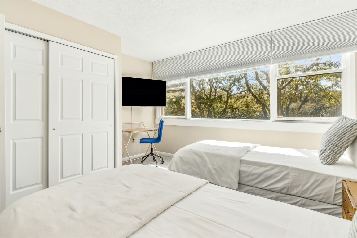 1107 Beach Walker Road, Unit 1107 Fernandina Beach, FL 32034 - Photo 28 of 63 a living room with a bed furniture and a flat screen tv
