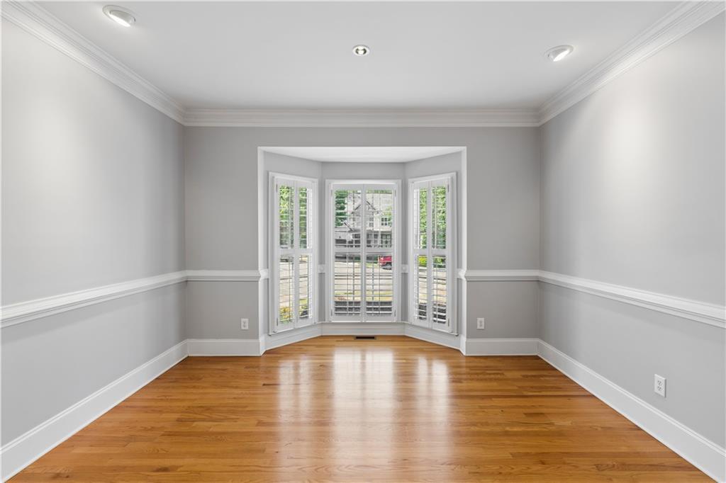 520 Redding View Court Northwest Sandy Springs, GA 30328 - Photo 6 of 27 wooden floor in an empty room with a window