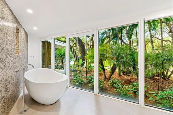 a room with a large window and tub