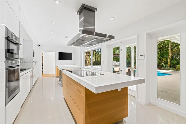 a kitchen with stainless steel appliances granite countertop a stove and a sink