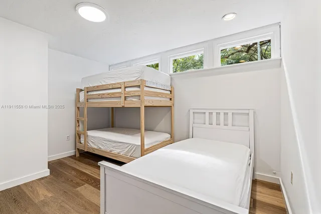 a bedroom with bed and a window