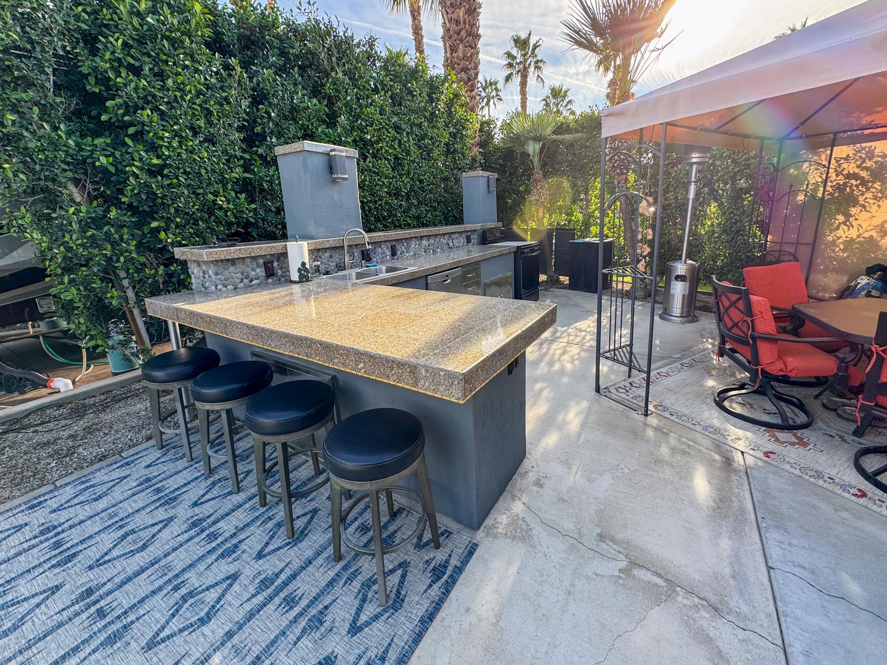 80394 Ave 48, Unit 36 Indio, CA 92201 - Photo 15 of 17 a view of a tables and chairs in patio
