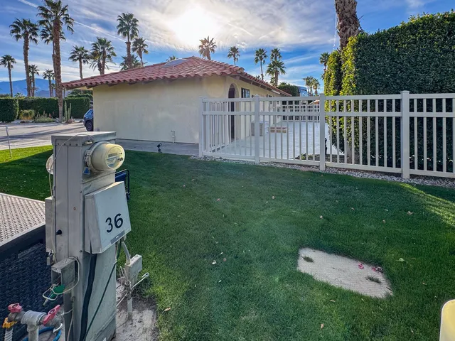 a backyard of a house with table and chairs