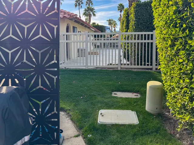 a backyard of a house with table and chairs