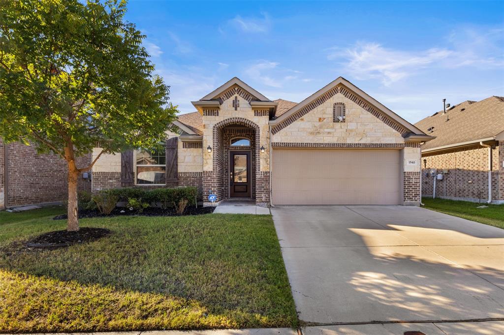 1740 Rio Costilla Road Fort Worth, TX 76131 - Photo 1 of 40 Brick and stone exterior with an arched entryway, attached garage, concrete driveway, and front landscaping