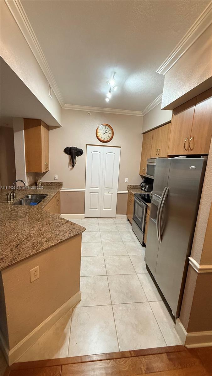 1830 Radius Drive, Unit 1105 Hollywood, FL 33020 - Photo 12 of 32 a kitchen with granite countertop a sink a stove and a refrigerator