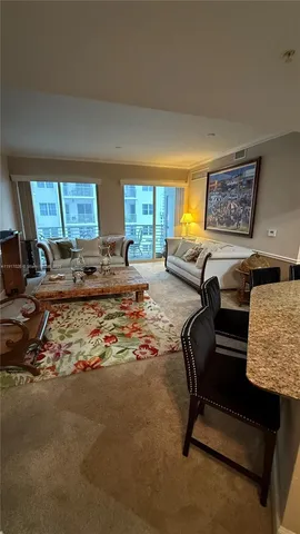 a living room with furniture chess board and a window