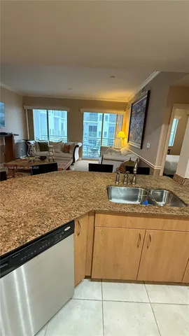 a kitchen with stainless steel appliances granite countertop a sink window and cabinets