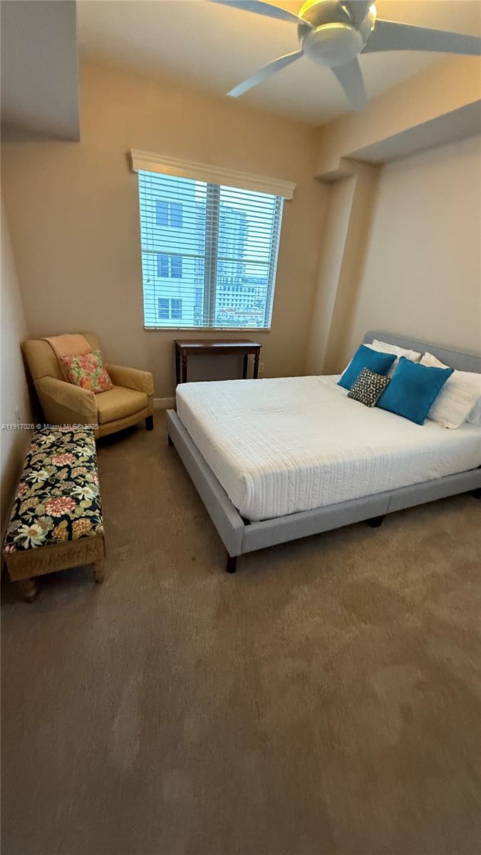 1830 Radius Drive, Unit 1105 Hollywood, FL 33020 - Photo 21 of 32 a bedroom with a bed and a couch