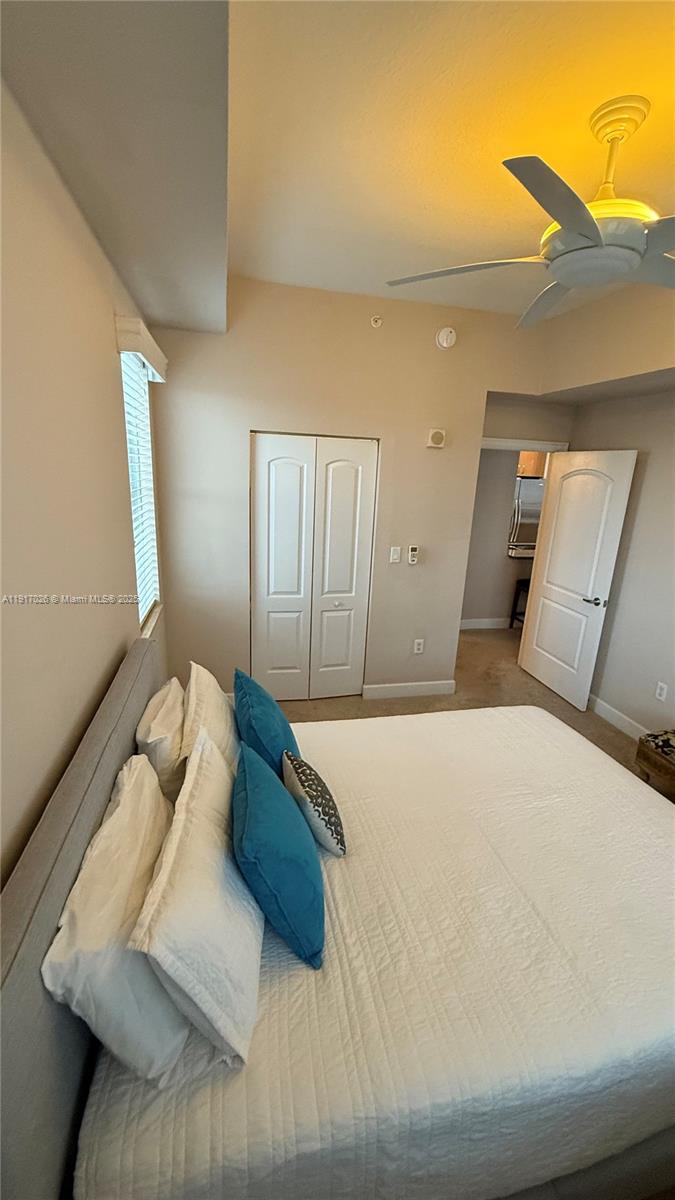 1830 Radius Drive, Unit 1105 Hollywood, FL 33020 - Photo 23 of 32 a bedroom with a large bed and a couch