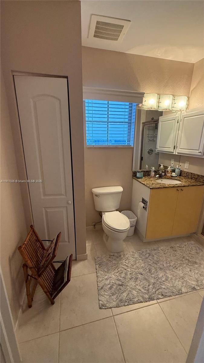1830 Radius Drive, Unit 1105 Hollywood, FL 33020 - Photo 24 of 32 a view of a bathroom with a sink and a mirror